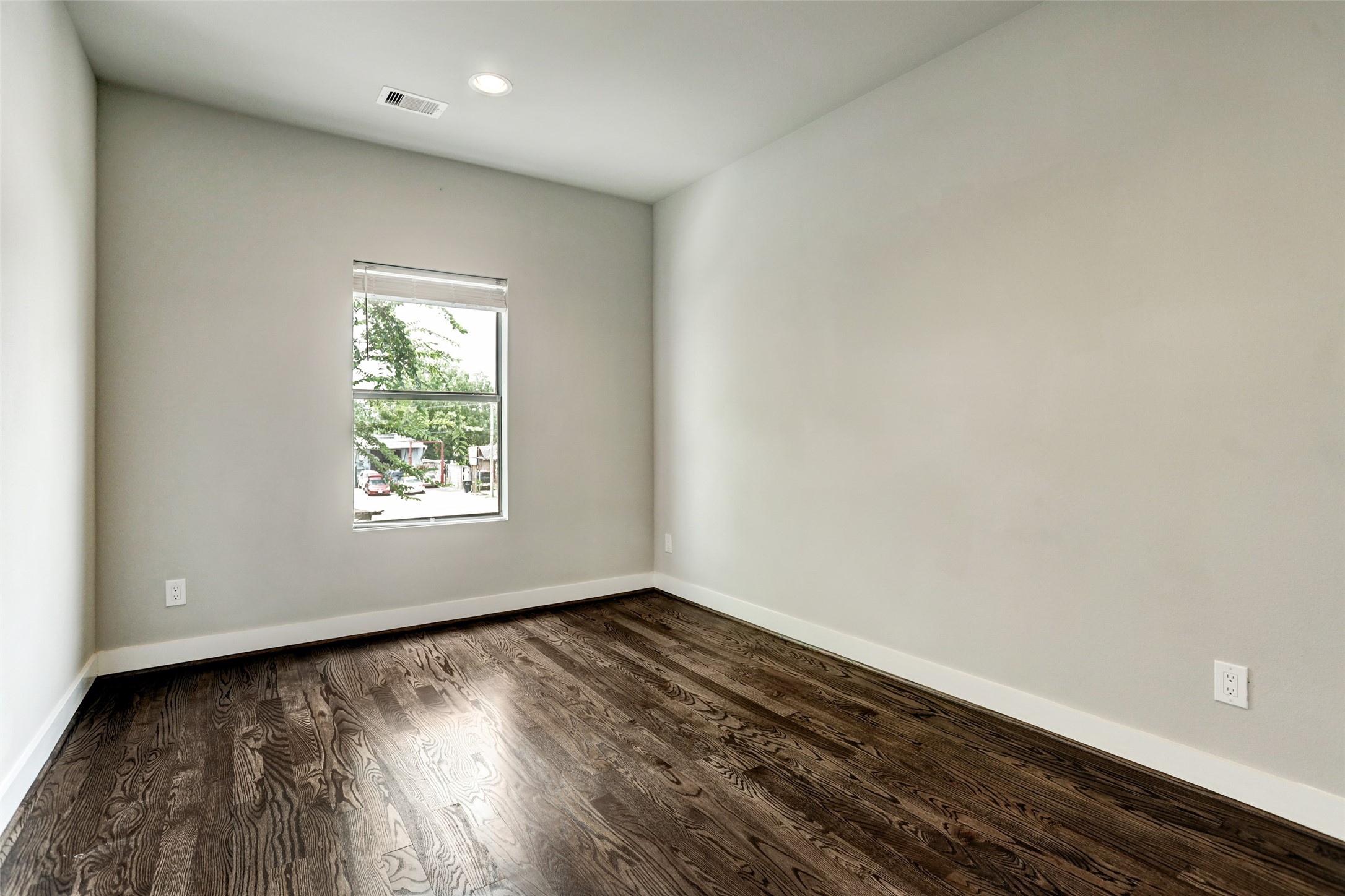 1309 Laird Street, Unit A Houston, TX 77008 - Photo 19 of 22 an empty room with wooden floor and windows