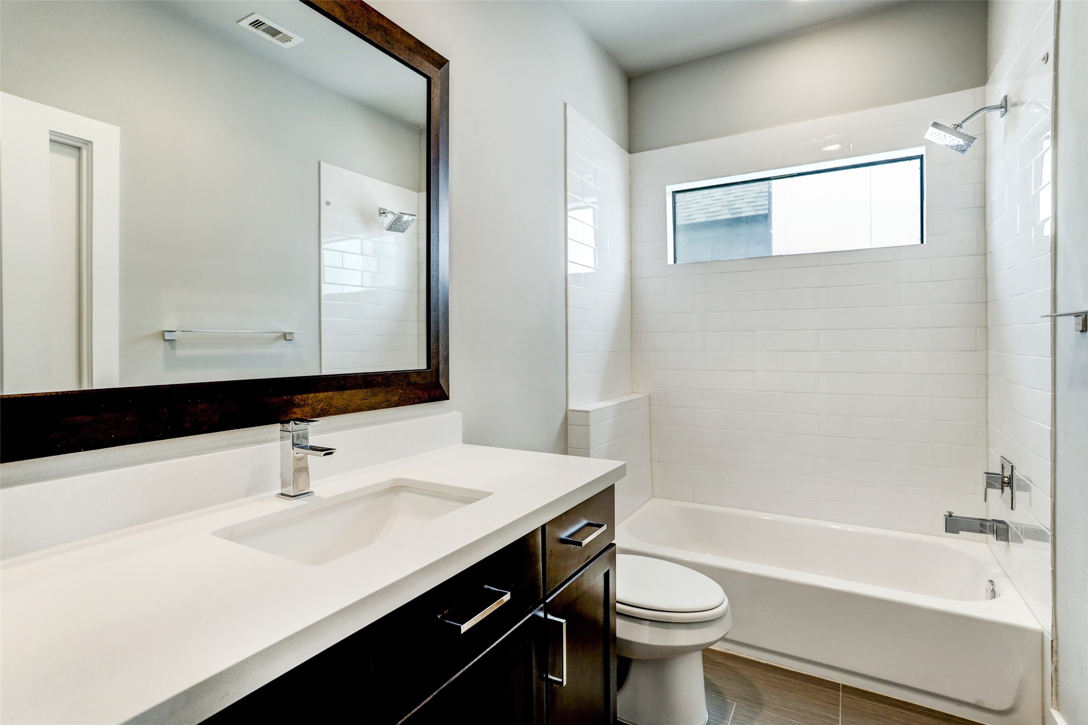 1309 Laird Street, Unit A Houston, TX 77008 - Photo 20 of 22 a bathroom with a sink a toilet a mirror and shower