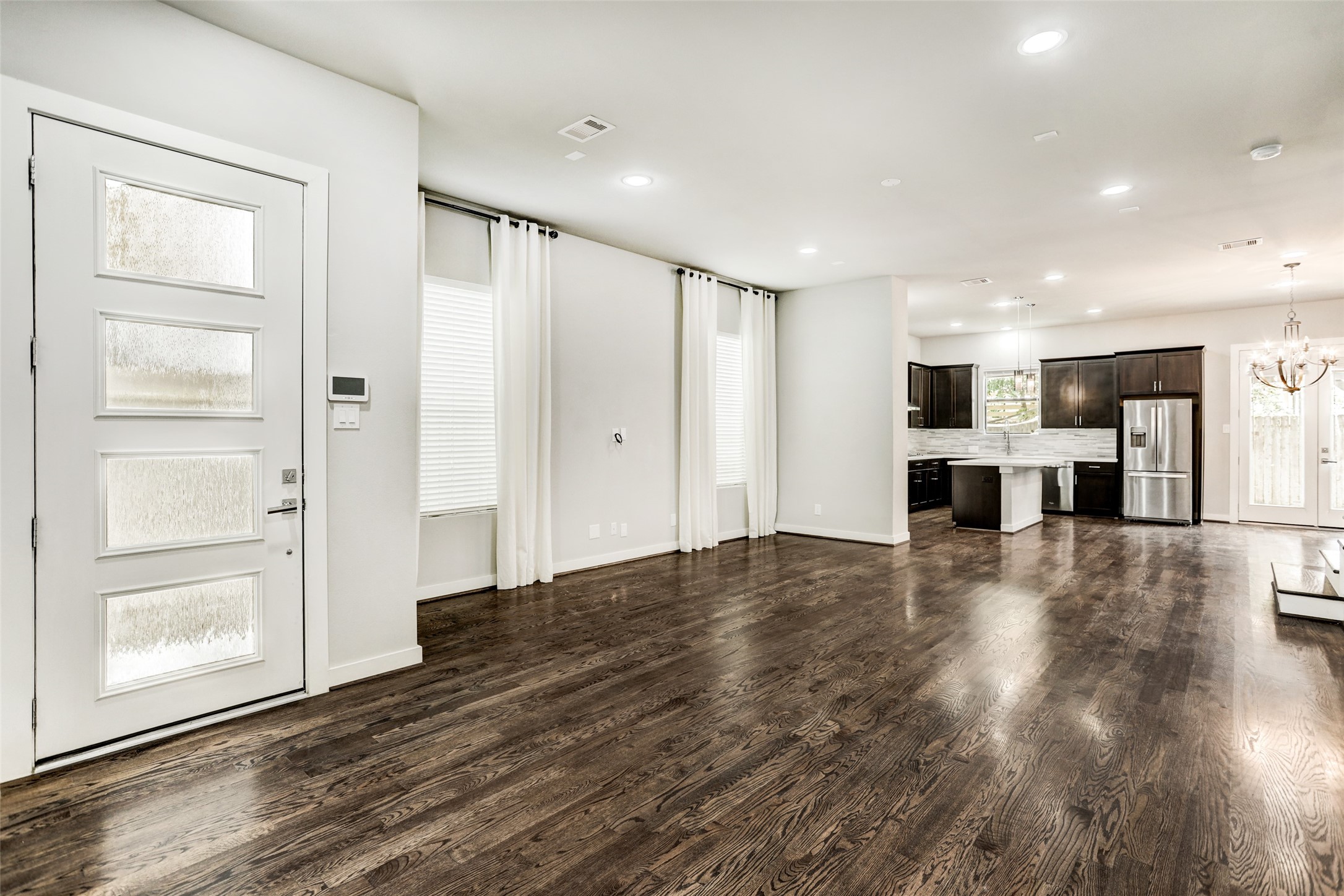 1309 Laird Street, Unit A Houston, TX 77008 - Photo 3 of 22 a view of a kitchen with a refrigerator and a window