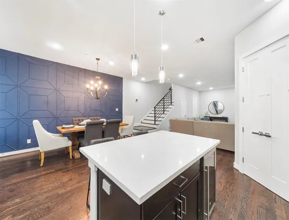 a large kitchen with a table and chairs