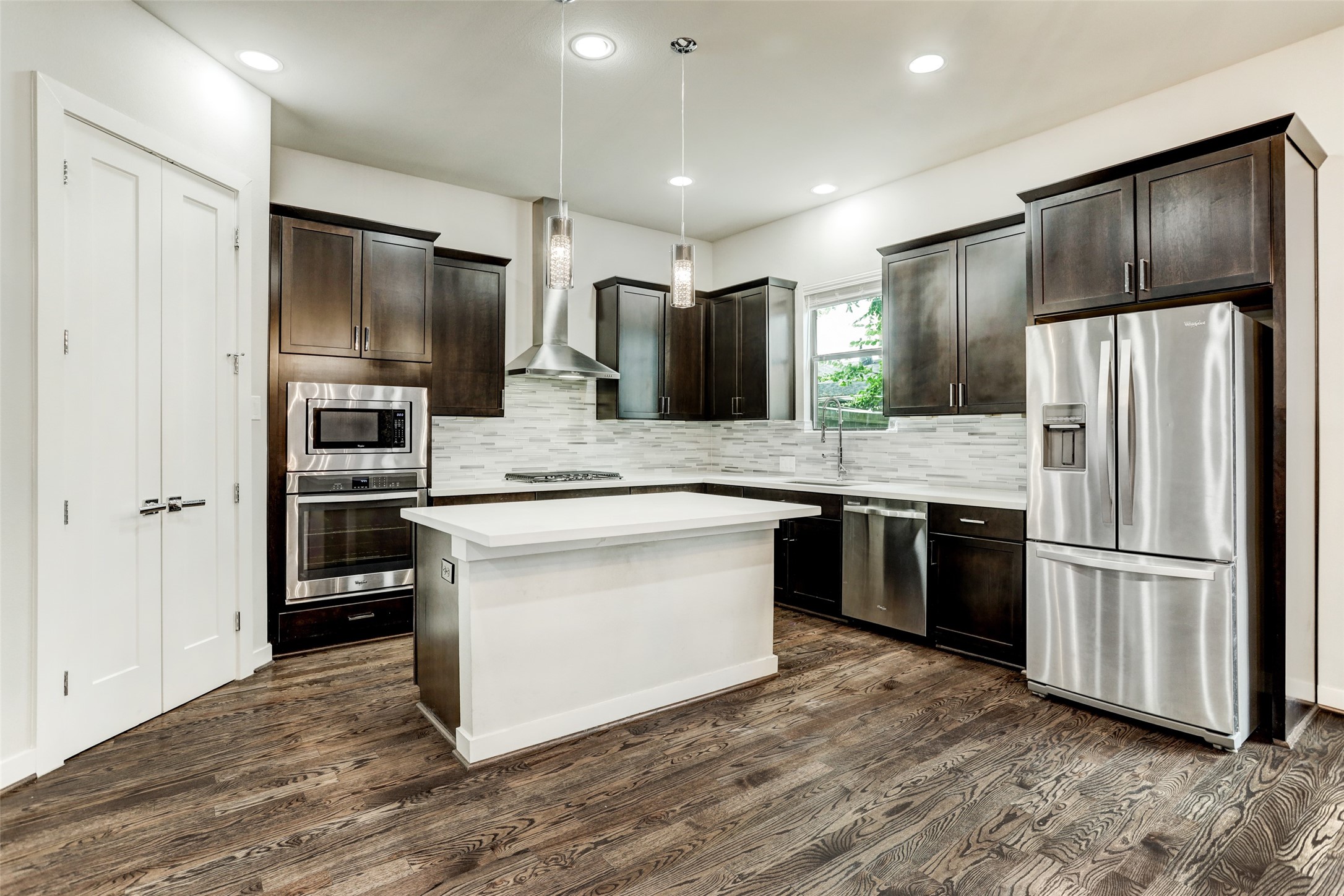 1309 Laird Street, Unit A Houston, TX 77008 - Photo 6 of 22 a kitchen with stainless steel appliances kitchen island granite countertop a refrigerator and a stove top oven