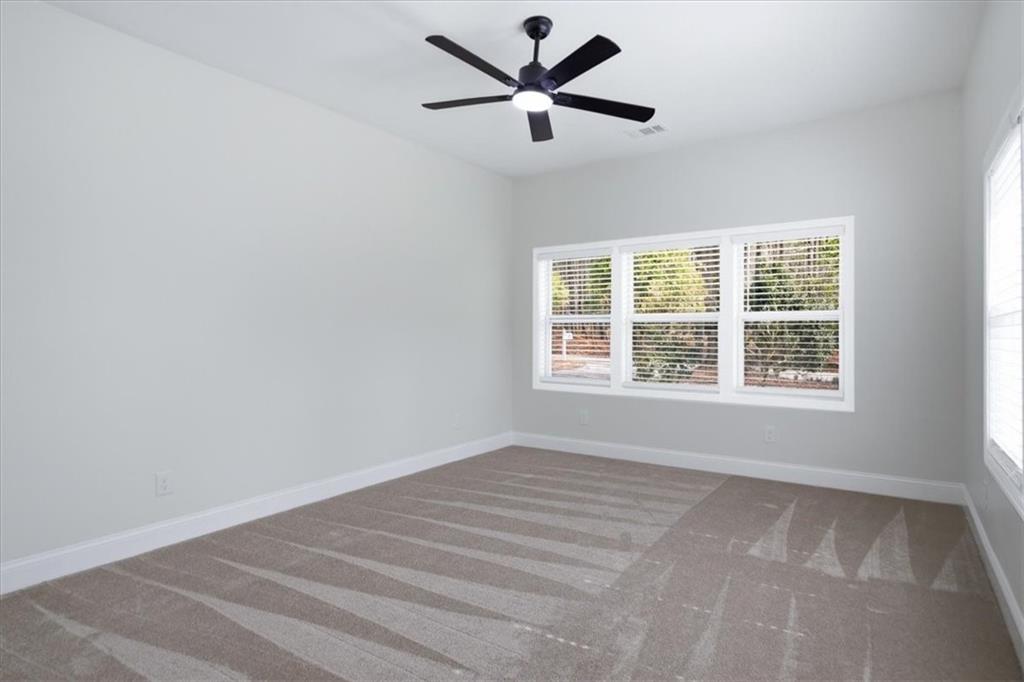 4911 Lower Jersey Road Oxford, GA 30054 - Photo 15 of 56 a view of a livingroom with a ceiling fan and window