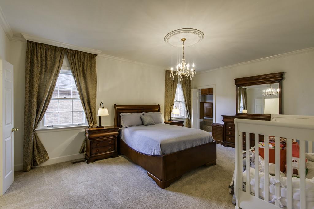110 Prospect Hill Nashville, TN 37205 - Photo 12 of 23 a bedroom with a bed and a chandelier