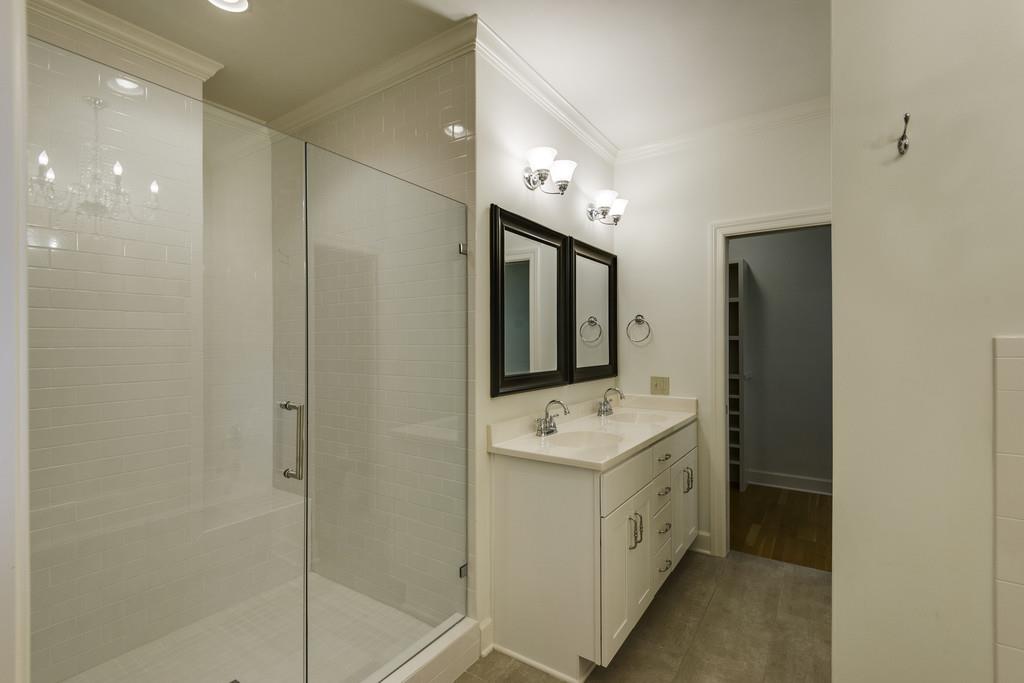 110 Prospect Hill Nashville, TN 37205 - Photo 13 of 23 a bathroom with a double vanity sink a mirror and a bathtub