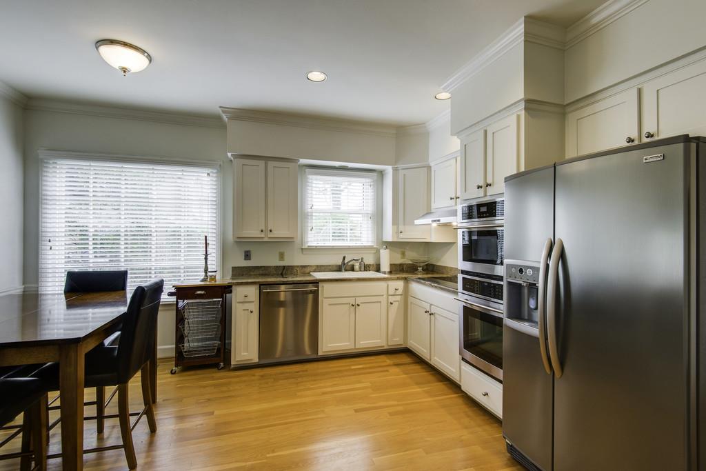 110 Prospect Hill Nashville, TN 37205 - Photo 8 of 23 a kitchen with stainless steel appliances granite countertop a stove refrigerator sink and cabinets
