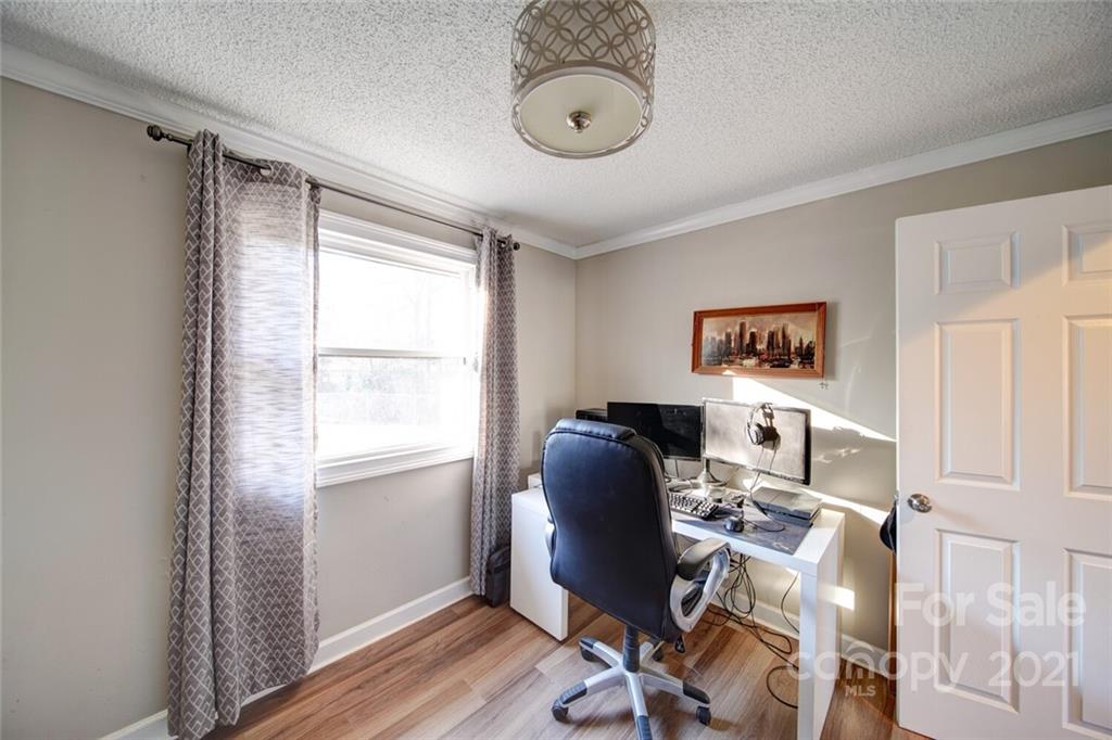 1032 Ravendale Drive Charlotte, NC 28216 - Photo 12 of 20 a view of a workspace with furniture and a window