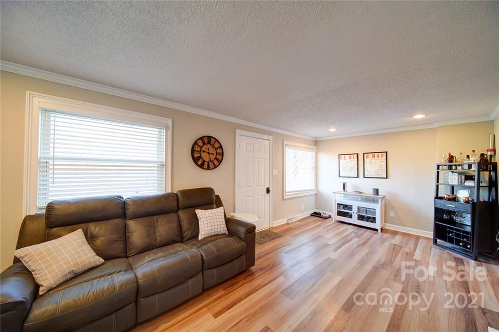 1032 Ravendale Drive Charlotte, NC 28216 - Photo 3 of 20 a living room with furniture and a wooden floor