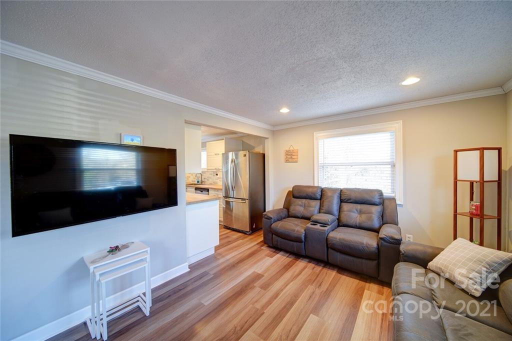 1032 Ravendale Drive Charlotte, NC 28216 - Photo 5 of 20 a living room with furniture and a flat screen tv