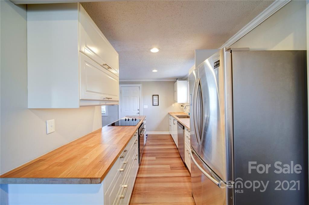 1032 Ravendale Drive Charlotte, NC 28216 - Photo 6 of 20 a kitchen with stainless steel appliances granite countertop a refrigerator and a sink