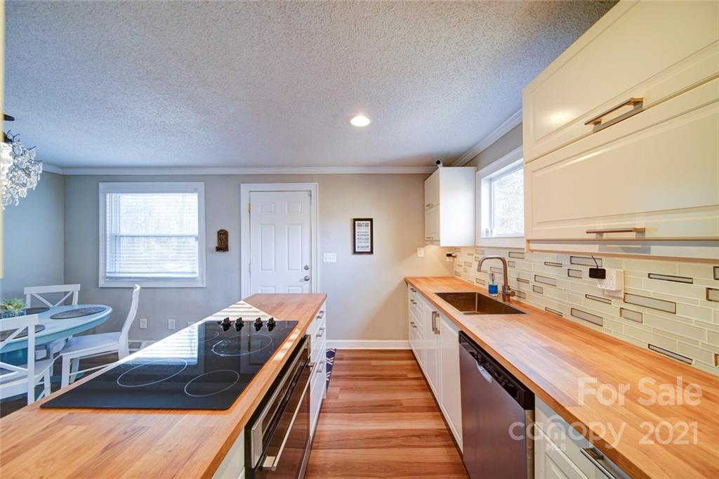 1032 Ravendale Drive Charlotte, NC 28216 - Photo 8 of 20 a kitchen with stainless steel appliances granite countertop a sink and stove