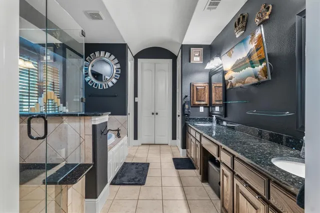 a kitchen with stainless steel appliances granite countertop a sink and a stove