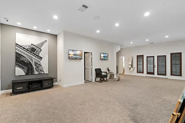 an empty room with furniture and large window