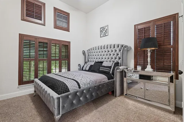 a bed sitting in a bedroom next to a window