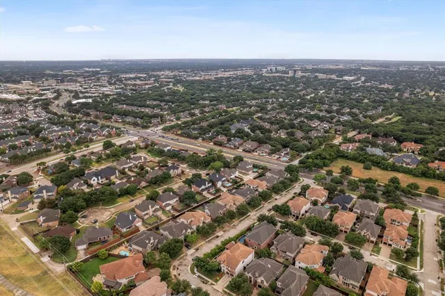 an aerial view of residential houses with city view