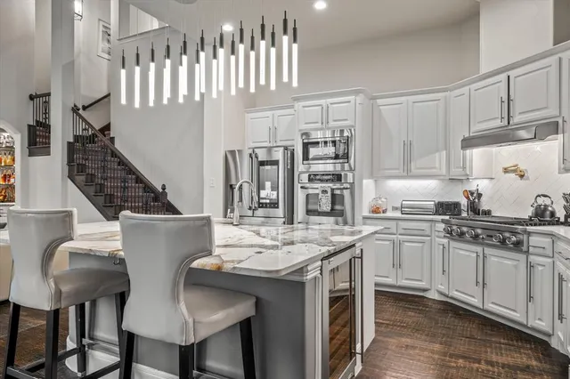 a kitchen with cabinets table and chairs