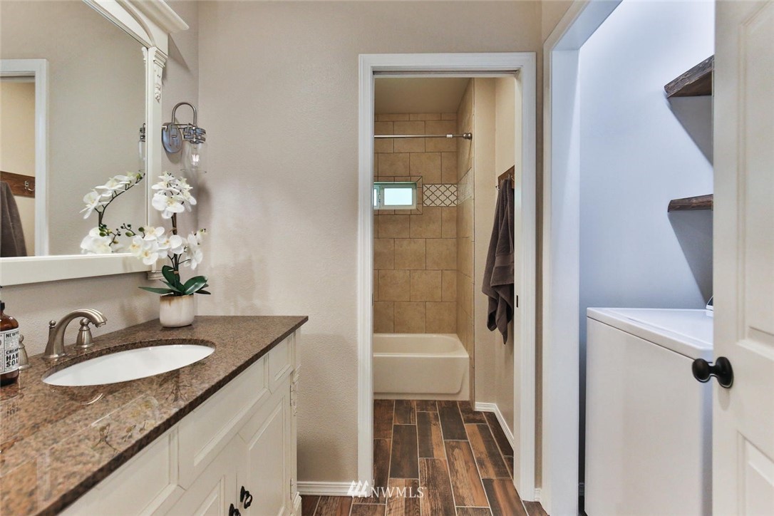 15519 OK Mill Road Snohomish, WA 98290 - Photo 11 of 32 a bathroom with a granite countertop sink a toilet and a mirror