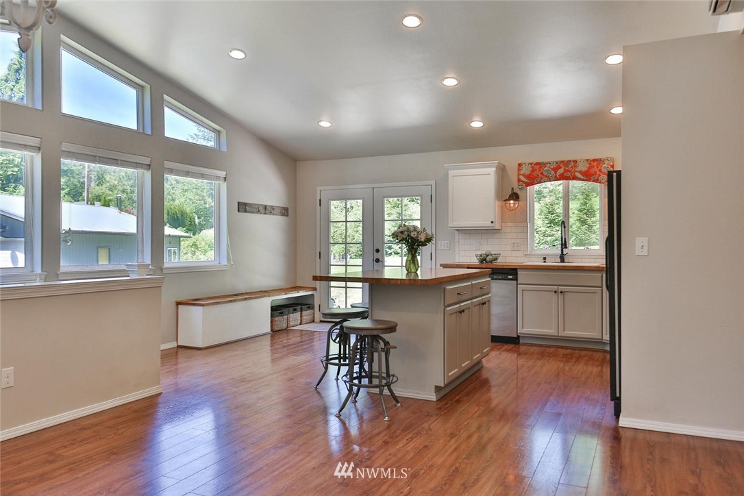 15519 OK Mill Road Snohomish, WA 98290 - Photo 6 of 32 a kitchen with a table chairs a sink dishwasher window and cabinets