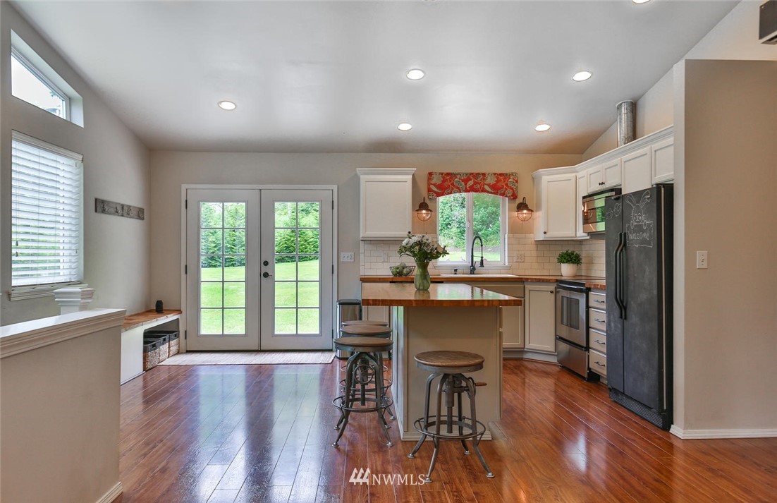 15519 OK Mill Road Snohomish, WA 98290 - Photo 7 of 32 a kitchen with a table chairs refrigerator and cabinets