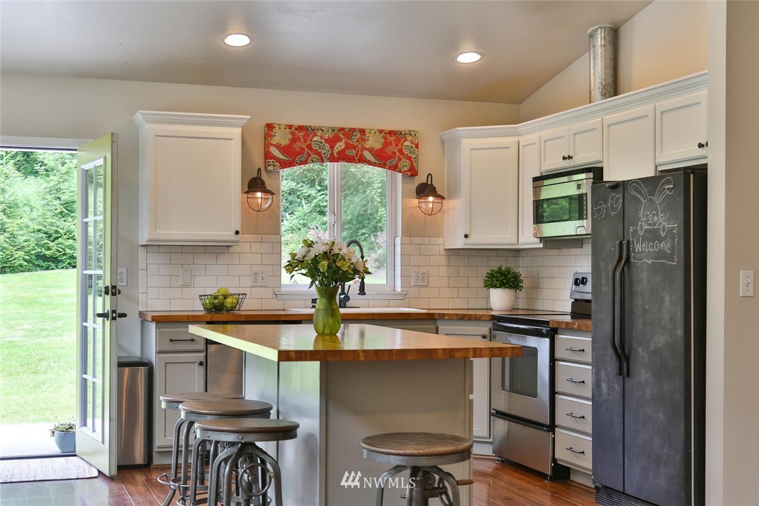 15519 OK Mill Road Snohomish, WA 98290 - Photo 8 of 32 a kitchen with stainless steel appliances a sink and a refrigerator