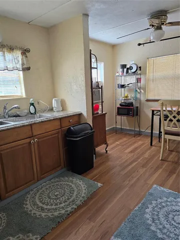 a room with wooden floor and furniture