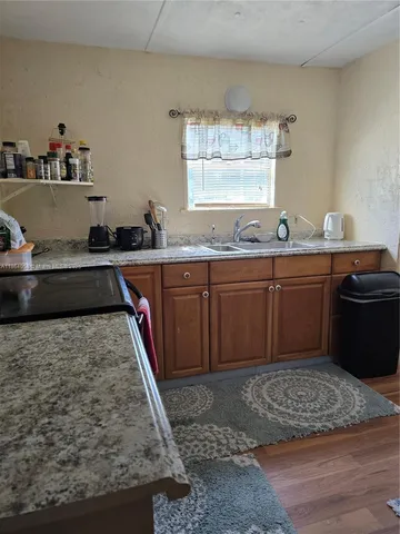 a kitchen with wooden cabinets and sink