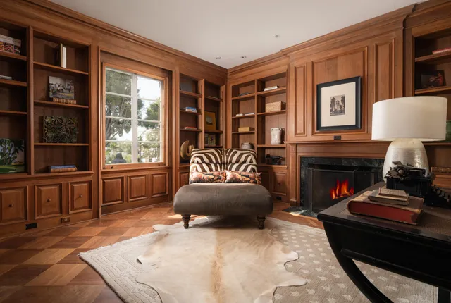a living room with furniture a window and a fireplace
