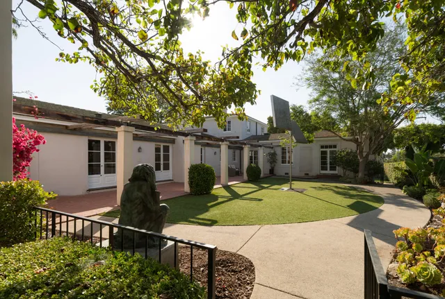 a house view with a sitting space and garden