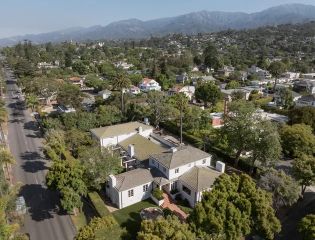 an aerial view of a house with a yard