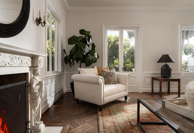 a living room with furniture a window and a fireplace