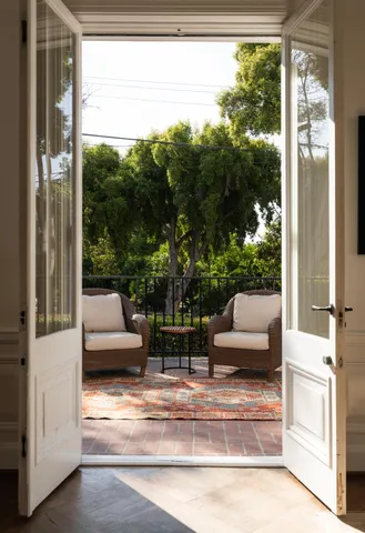 a view of living room with patio furniture and a yard