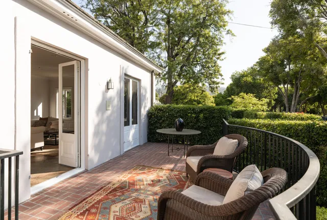 a view of balcony with furniture and garden
