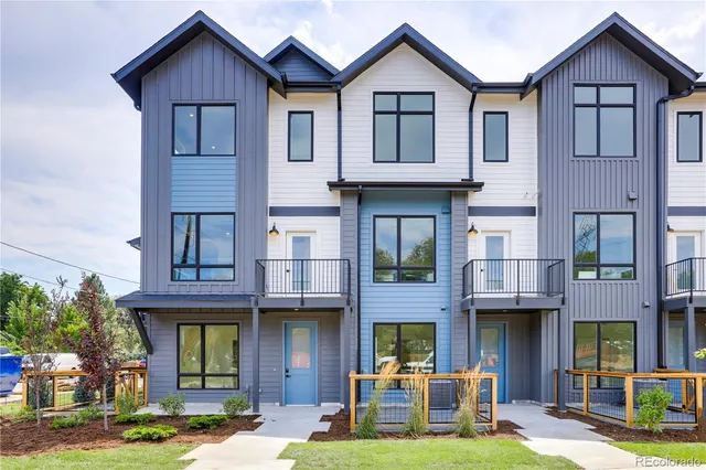 a view of a large brick building next to a yard