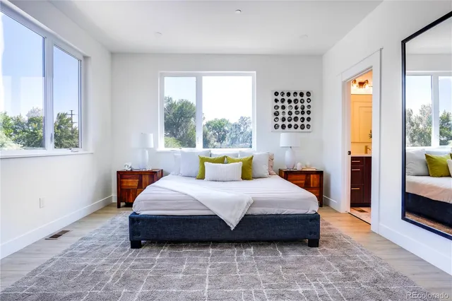 a bedroom with a bed and a large window