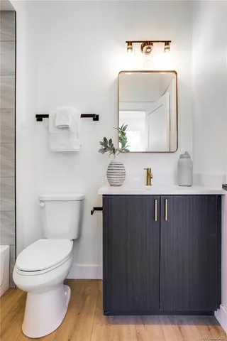 a bathroom with a toilet a sink and mirror