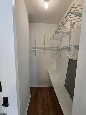 a view of walk in closet with empty racks