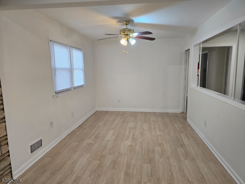 67 Lindsley Avenue Irvington, NJ 07111 - Photo 6 of 12 a view of a livingroom with a fan