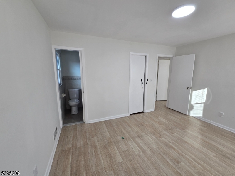 67 Lindsley Avenue Irvington, NJ 07111 - Photo 10 of 12 a view of a room with wooden floor and closet