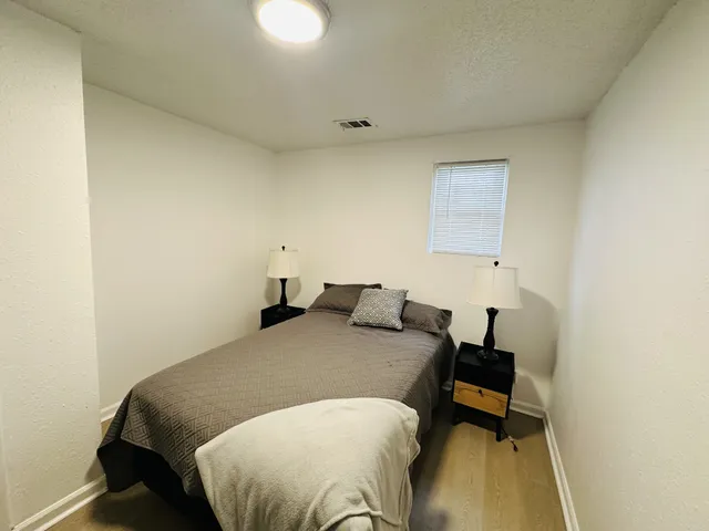 a bedroom with a bed and a table in it
