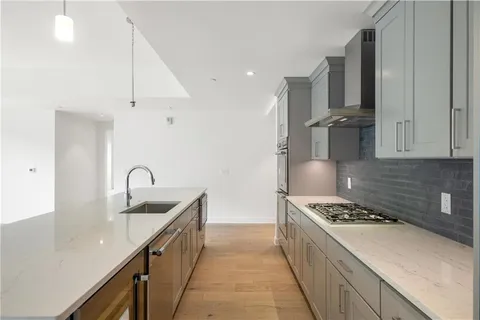 a kitchen with stainless steel appliances granite countertop a sink and a stove