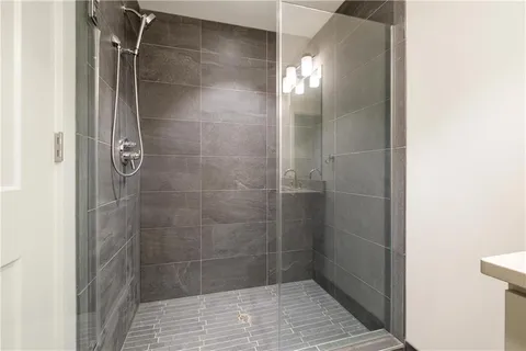 a bedroom with a two beds and a potted plant