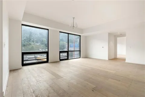 a view of a kitchen with a sink and a refrigerator