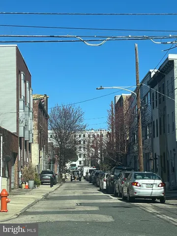 a view of a building and car parked on the road