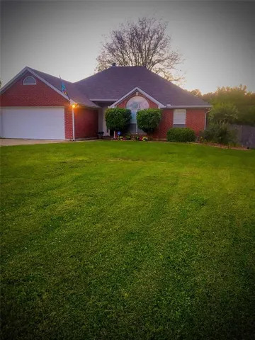 a view of house with yard and green space