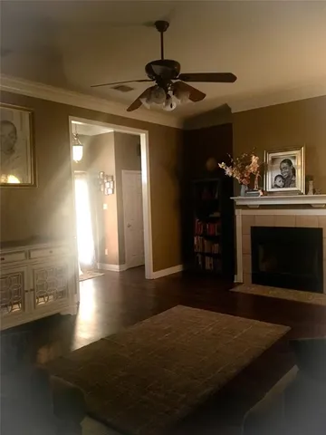 a living room with hard wood floors and a fireplace