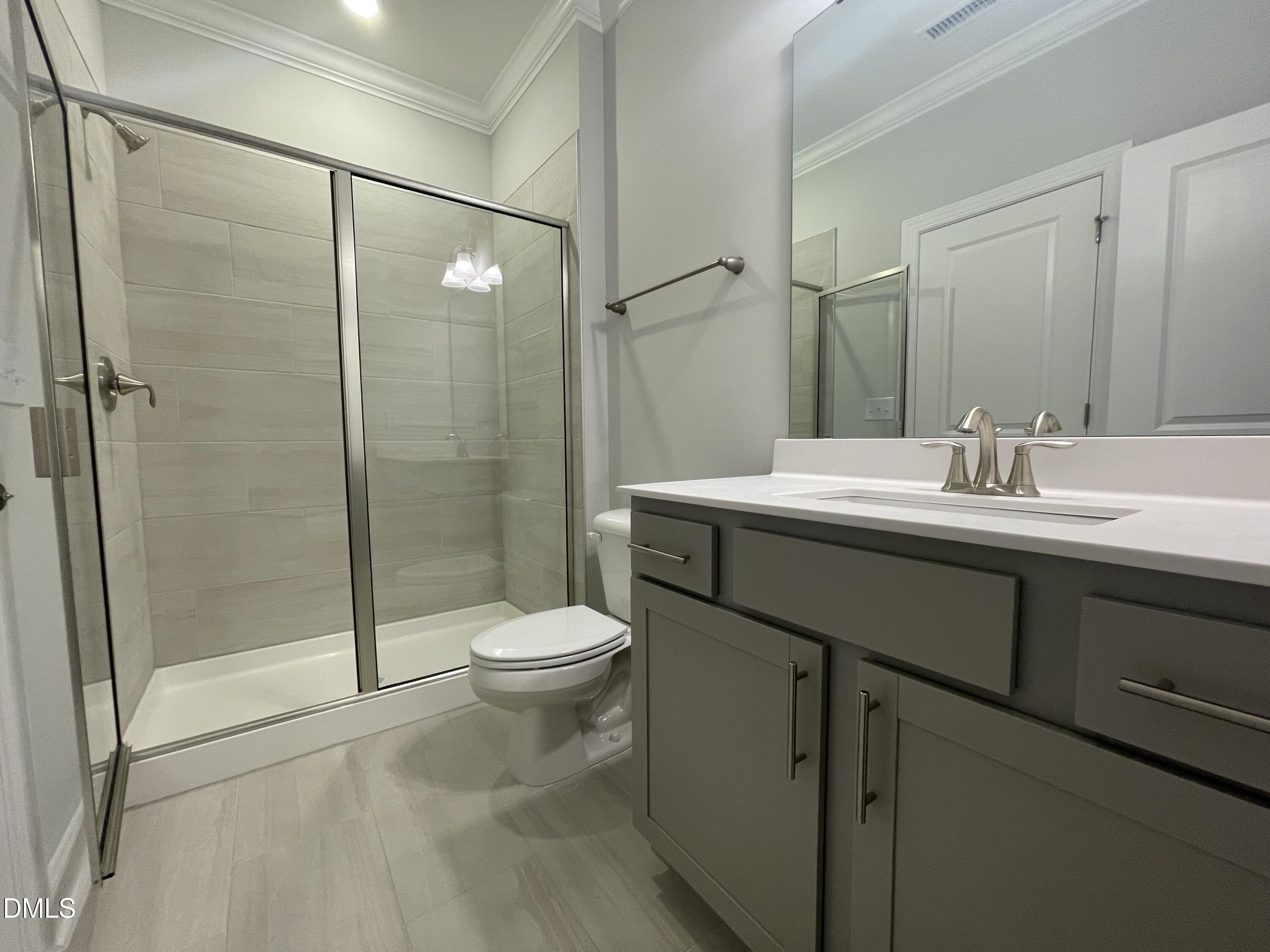 207 Edge Of Auburn Boulevard Raleigh, NC 27610 - Photo 11 of 32 a bathroom with a sink a toilet and shower