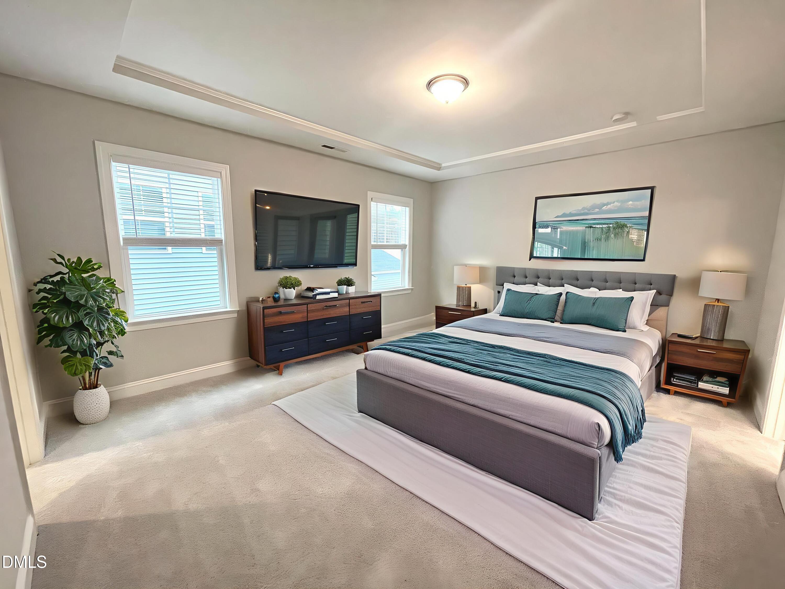 207 Edge Of Auburn Boulevard Raleigh, NC 27610 - Photo 13 of 32 a bedroom with a bed and flat screen tv