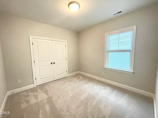 a spacious bathroom with a double vanity sink and a mirror
