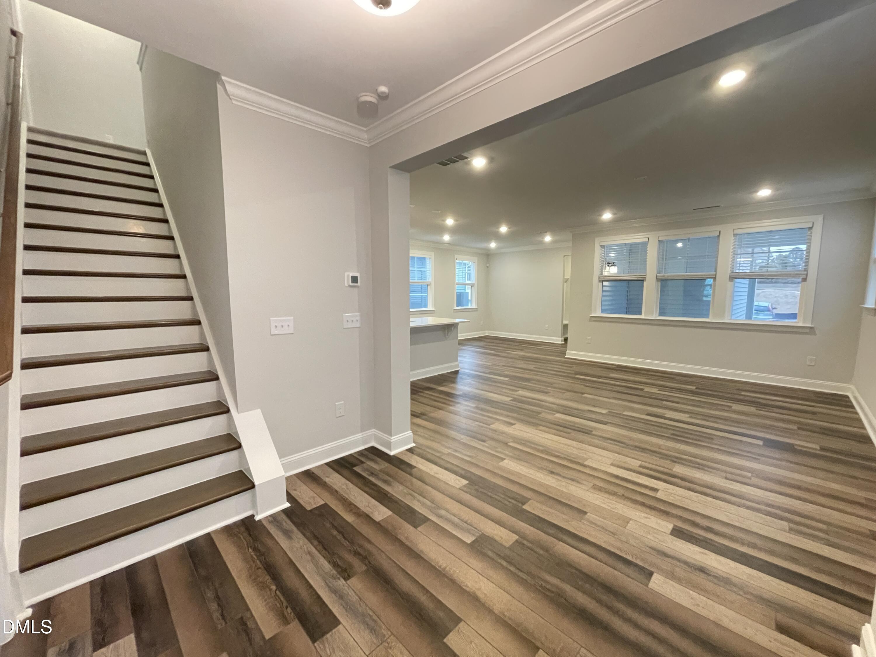 207 Edge Of Auburn Boulevard Raleigh, NC 27610 - Photo 2 of 32 a view of a room with wooden floor and stairs