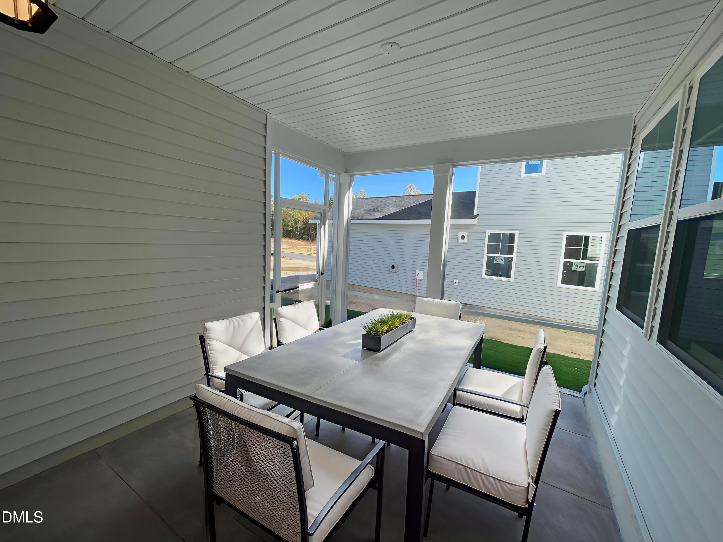 207 Edge Of Auburn Boulevard Raleigh, NC 27610 - Photo 25 of 32 a view of a patio with table and chairs with wooden floor and fence