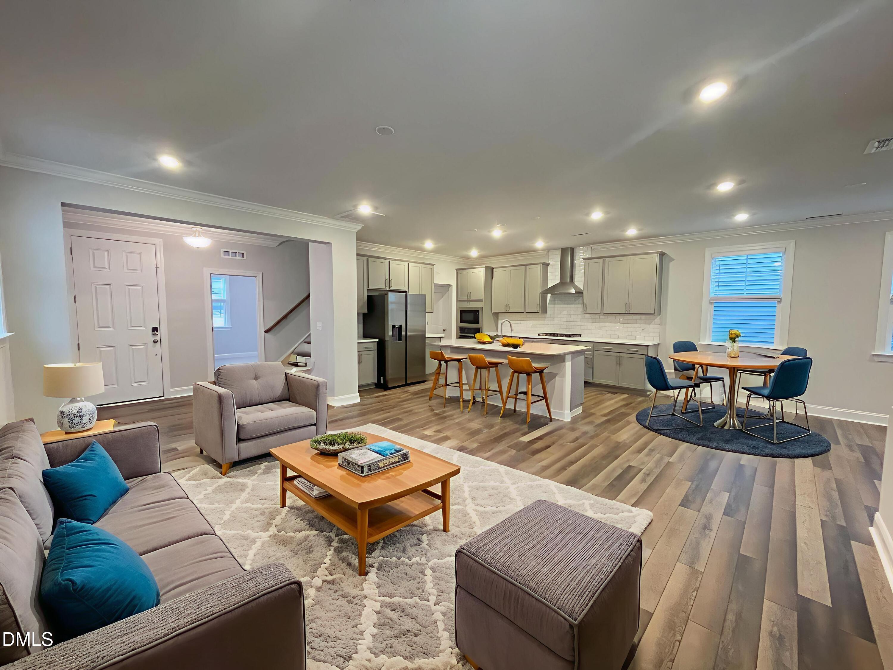 207 Edge Of Auburn Boulevard Raleigh, NC 27610 - Photo 4 of 32 a living room with furniture kitchen and a table